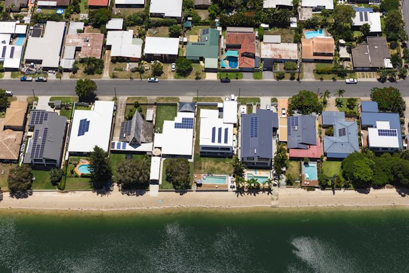Solar panels on suburban waterfront homes, Australia